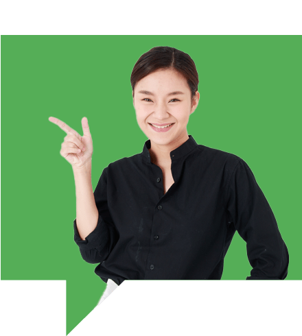 A person wearing a black shirt is smiling and pointing to the side with one hand. The background is a solid green color.