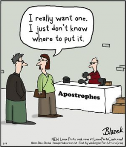 A cartoon shows a man and woman at an "Apostrophes" stand. The man admits, "I really want one. I just don’t know how to use an apostrophe." A vendor sits behind a table full of apostrophes, ready to help.