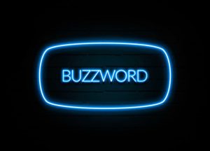 A neon sign displaying the word "BUZZWORD" in bright blue letters on a dark background, surrounded by an oval neon outline.