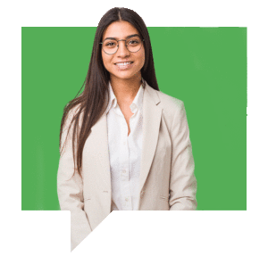 A person with long dark hair, wearing glasses and a light-colored suit jacket over a white shirt, smiling in front of a green background.