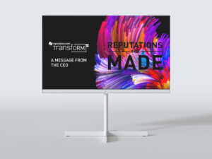 A computer monitor displays a colorful abstract graphic with the text "REPUTATIONS ARE MADE" on the right. On the left, it shows "reputation.com Transform '21 A MESSAGE FROM THE CEO" on a black background.