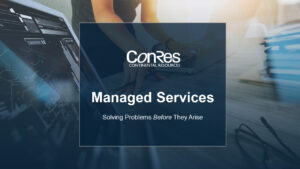A person working on a laptop next to a desk with documents. The text says "ConRes Continental Resources - Managed Services - Solving Problems Before They Arise" on a dark blue overlay.
