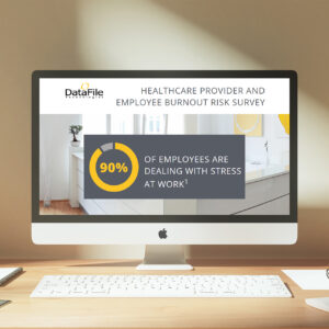 A computer monitor on a desk displays a survey titled "Healthcare Provider and Employee Burnout Risk Survey" from DataFile. A circular chart indicates that 90% of employees are dealing with stress at work.