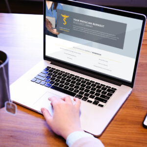 A person using a laptop on a wooden table. The screen displays a website titled "Your Physician Burnout Resource Library." A coffee cup is visible on the left side of the image.
