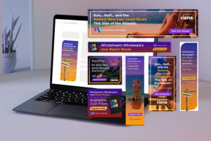 A laptop on a table displays colorful digital ads for Windstream Wholesale's new beach route, featuring tropical designs, pineapples, and text promoting fast fiber and great diversity. A plant is in the background.