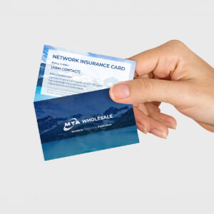 A hand holding two cards: one is a network insurance card with contact details for policy assistance; the other is an advertisement for MTA Wholesale with a tagline "Solutions Powered by Experience," both featuring a mountain and lake background.