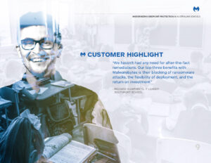 A smiling man in glasses is overlaid on an image of a classroom with students working. The text highlights a customer testimonial about Malwarebytes' benefits in schools, focusing on ransomware protection and investment returns, attributed to Richard Humphreys.