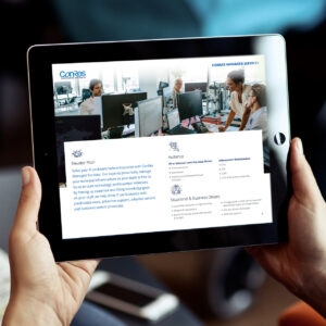 A person holds a tablet displaying a webpage for Connes Managed Services. The screen shows images of people working in an office, along with text about service offerings, audience, and business drivers.