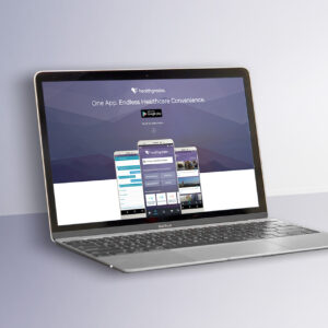 A laptop displays a website promoting a healthcare app. The screen shows the text "One App. Endless Healthcare Convenience" with images of a smartphone interface and download options from Google Play and App Store. The laptop rests on a white surface.