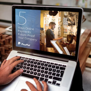 Person using a laptop showing a PayPal presentation titled "5 Ways Online Payments Future-Proof Your Company," with an image of someone working in a retail shop.