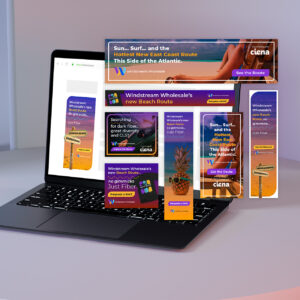 A laptop displaying multiple colorful digital ads featuring text about Windstream Wholesale's new beach route and routes to Atlanta. The ads include vibrant graphics with surfboards and ocean themes.