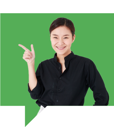 A person wearing a black shirt is smiling and pointing to the side with one hand. The background is a solid green color.