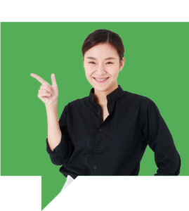 A person with short dark hair, wearing a black shirt, is smiling while pointing with their right hand against a bright green background.