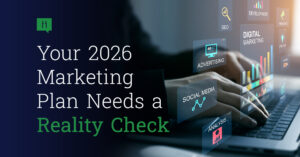 A person types on a laptop with digital marketing icons and graphs floating above the keyboard. Text reads: Your 2026 Marketing Plan Needs a Reality Check—stay ahead with data-driven strategies.